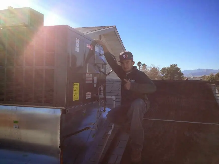 HVAC technician performing HVAC Inspection on a rooftop unit in Elizabeth City